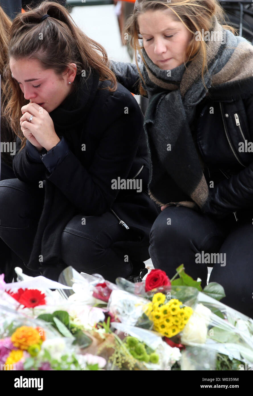 People mourn in front of Le Carillon bistro and Le Petit Cambodge restaurant on November 16, 2015. More than one hundred people were killed and many more wounded when gunmen opened fire at multiple locations across the French capital during a series of deadly attacks on November 13. Photo by Maya Vidon-White/UPI Stock Photo