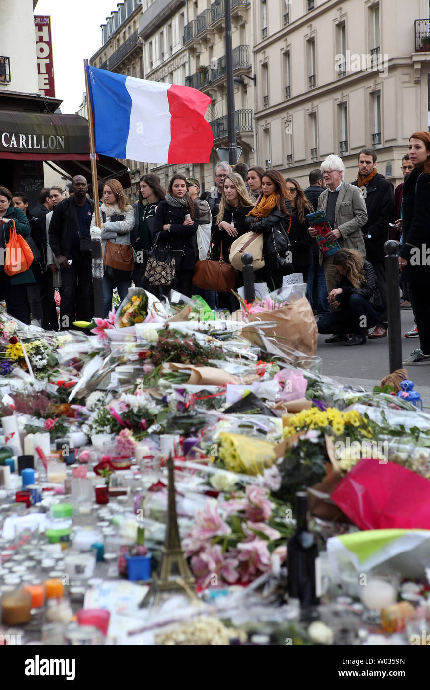 People mourn in front of Le Carillon bistro and Le Petit Cambodge restaurant on November 16, 2015. More than one hundred people were killed and many more wounded when gunmen opened fire at multiple locations across the French capital during a series of deadly attacks on November 13. Photo by Maya Vidon-White/UPI Stock Photo