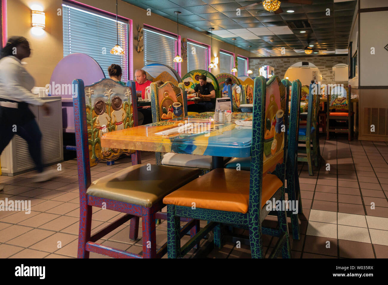 Diners enjoying dinner at a Mexican restaurant with colorful Mexican decor. Arkansas, USA. Stock Photo