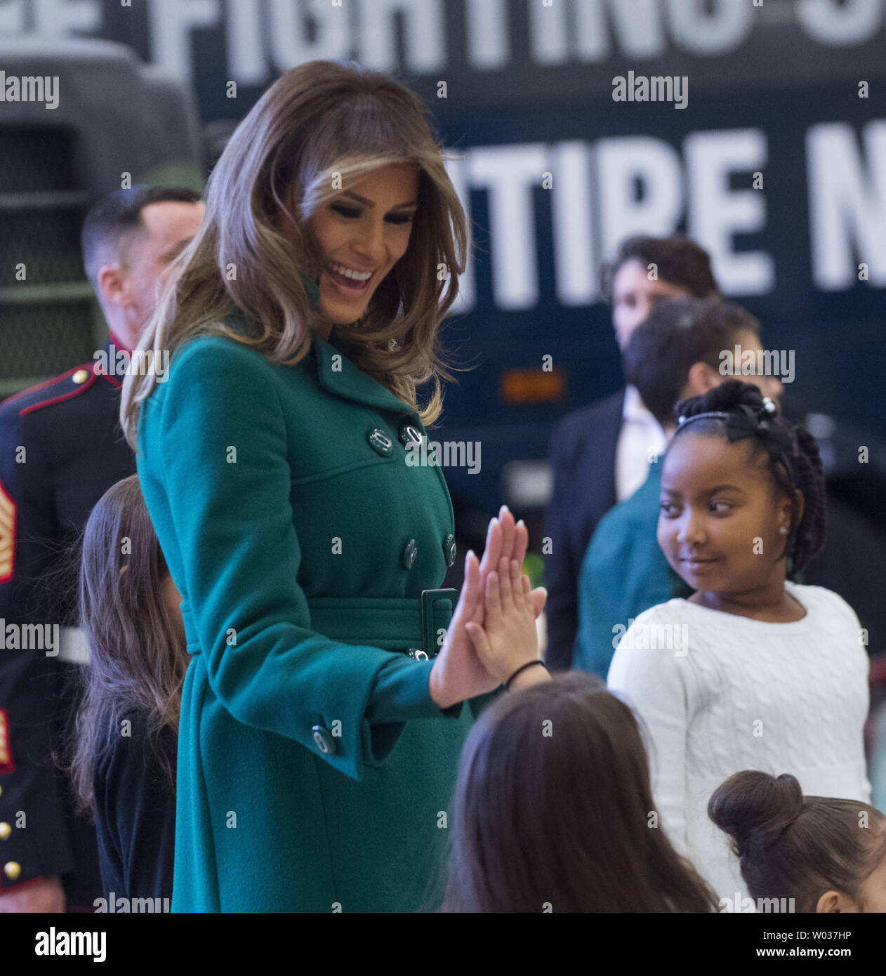 First Lady Melania Trump shakes hands with children as they participate in the Marine Corps Reserve Toys for Tots Campaign at Joint Base Anacostia-Bolling in Washington, D.C. on December 13, 2017. The first lady helped write holiday cards, sort and box toys at the base with military children to help other children in the DC area. Photo by Pat Benic/UPI Stock Photo