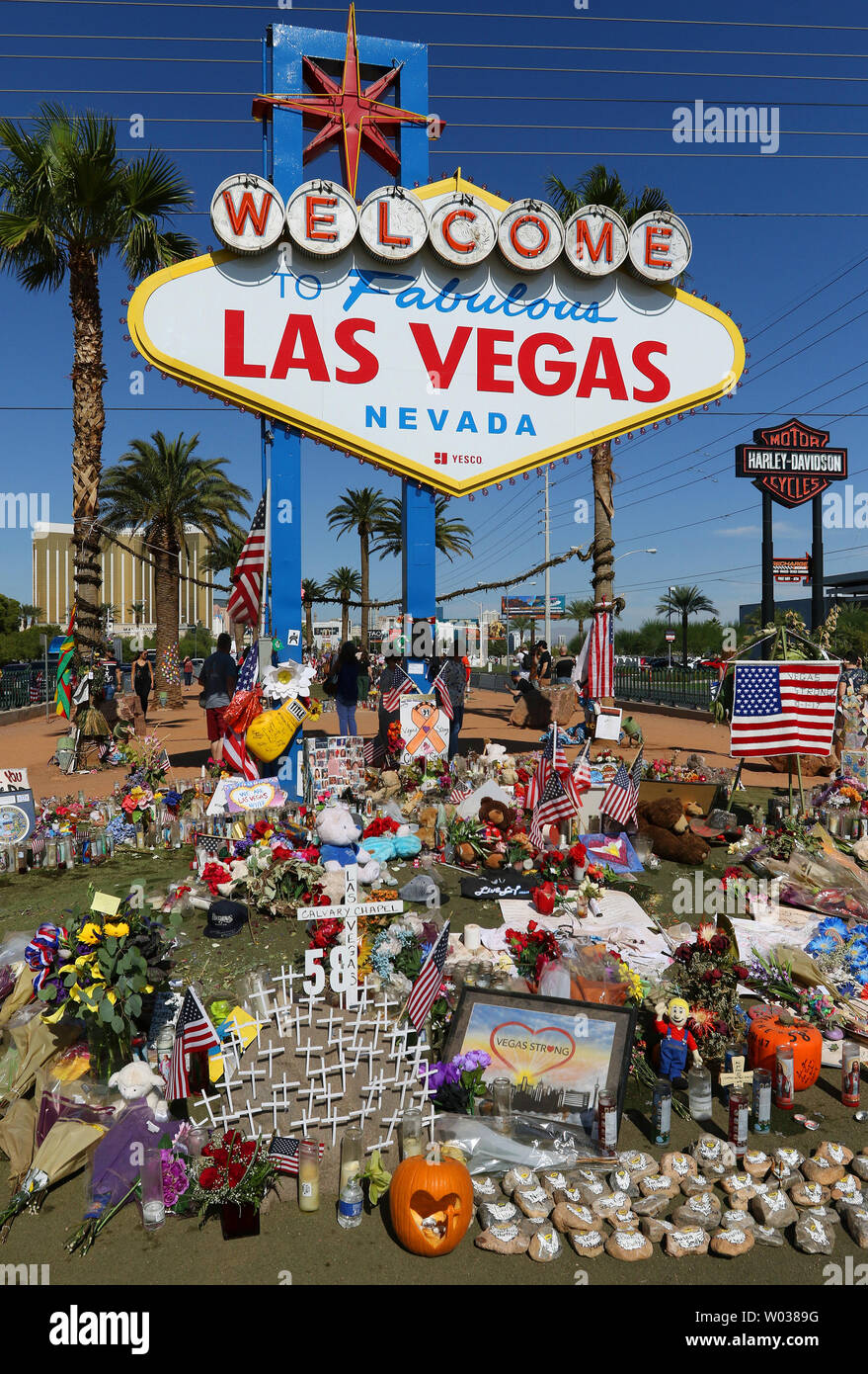 A memorial for the slain victims of the Route 91 Harvest music festival mass is shown next to the historic Welcome to Las Vegas sign October 19, 2017, in Las