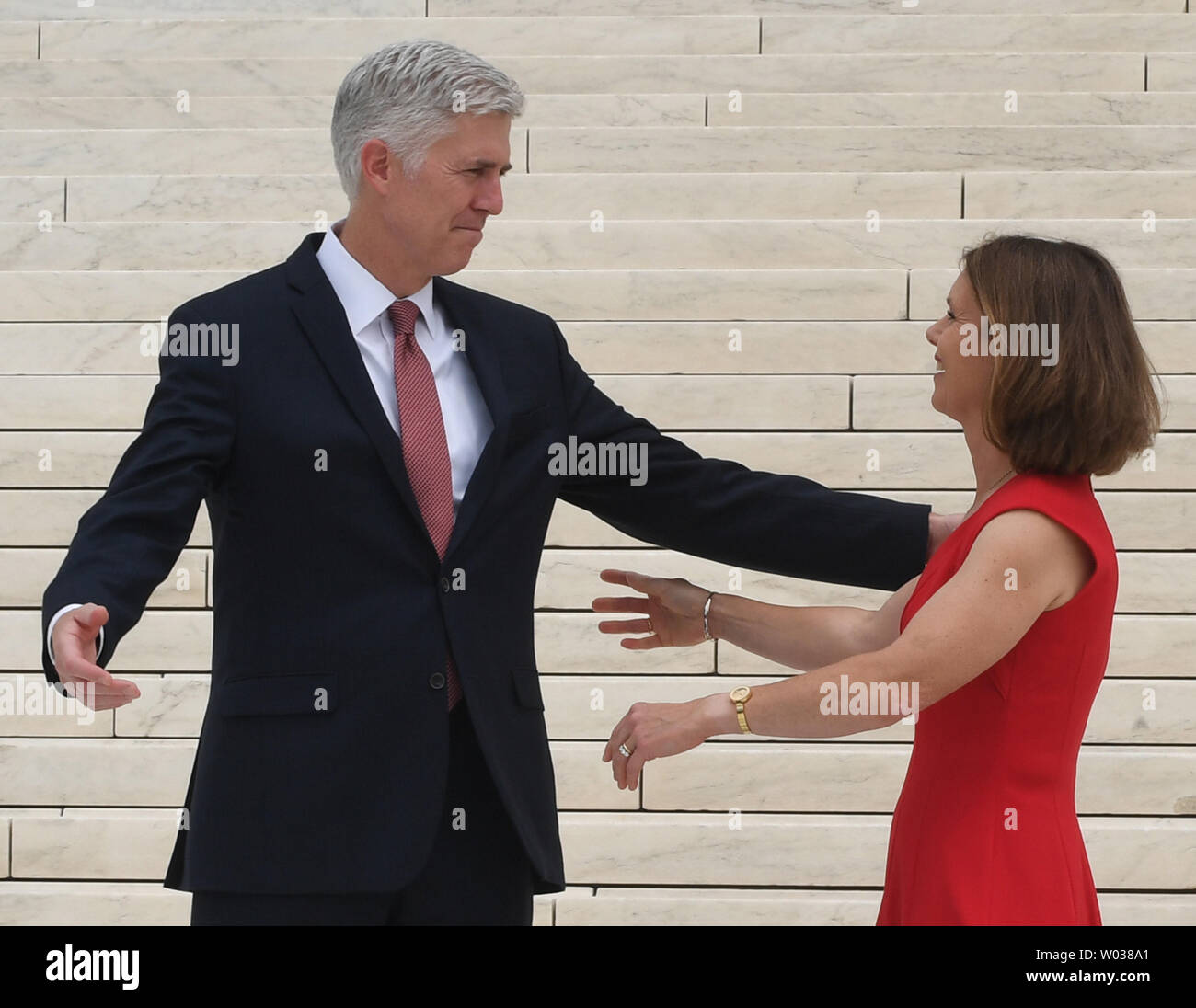 Associate Justice Neil Gorsuch L greets his wife Marie Louise on the steps to the Supreme Court in Washington D.C. on June 15 2017. Gorsuch is the newest member of the court