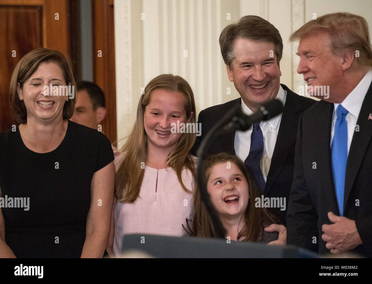 President Donald Trump smiles the the family of Brett Kavanaugh,  his  nominee for Supreme Court Justice, during a ceremony in the East Room at the White House in Washington, D.C., on July 9, 2018. Kavanaugh will be replacing retiring Justice Anthony Kennedy. (L-R) Wife Ashley, daughters Margaret and Liza, stand with Cavanaugh.   Photo by Pat Benic/UPI Stock Photo