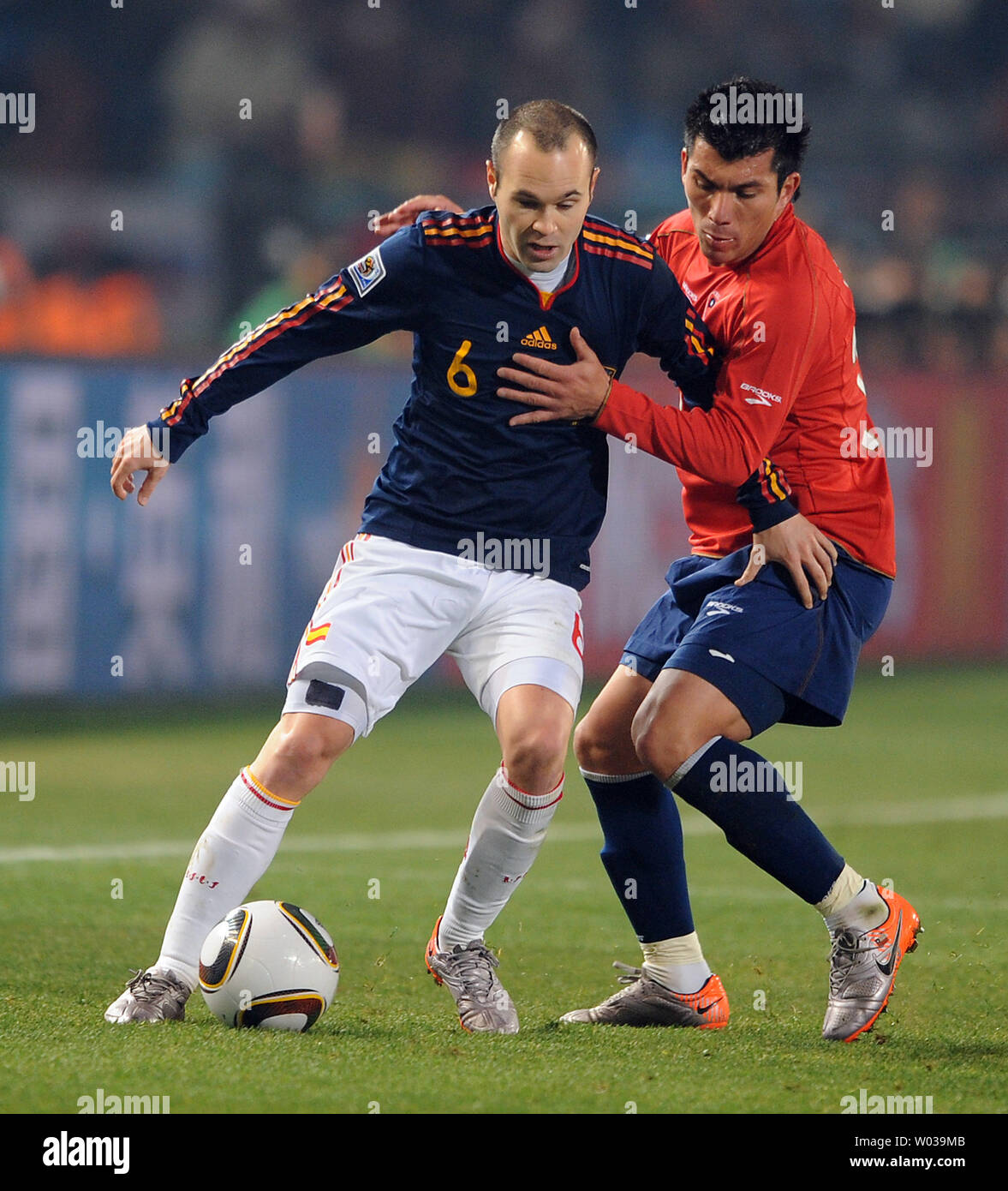 Gary Medel of Chile and Andres Iniesta of Spain chase the ball during the Group H match at the Loftus Versfeld Stadium in Pretoria, South Africa on June 25, 2010. UPI/Chris Brunskill Stock Photo