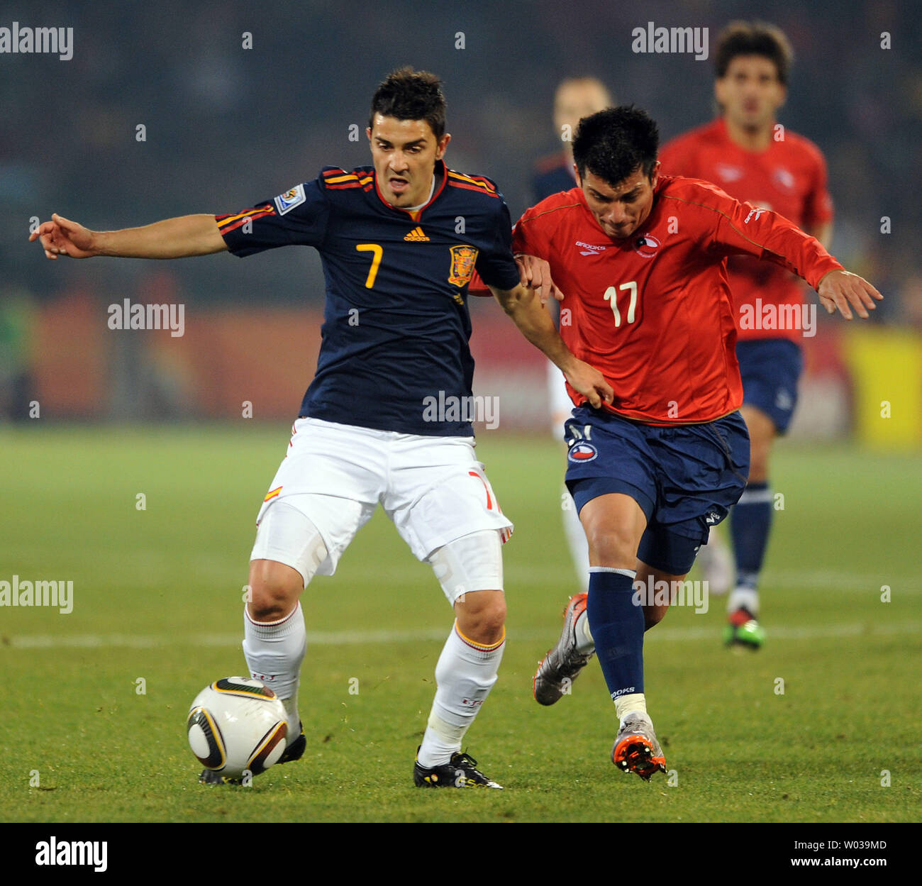 Gary Medel of Chile and David Villa of Spain chase the ball during the Group H match at the Loftus Versfeld Stadium in Pretoria, South Africa on June 25, 2010. UPI/Chris Brunskill Stock Photo