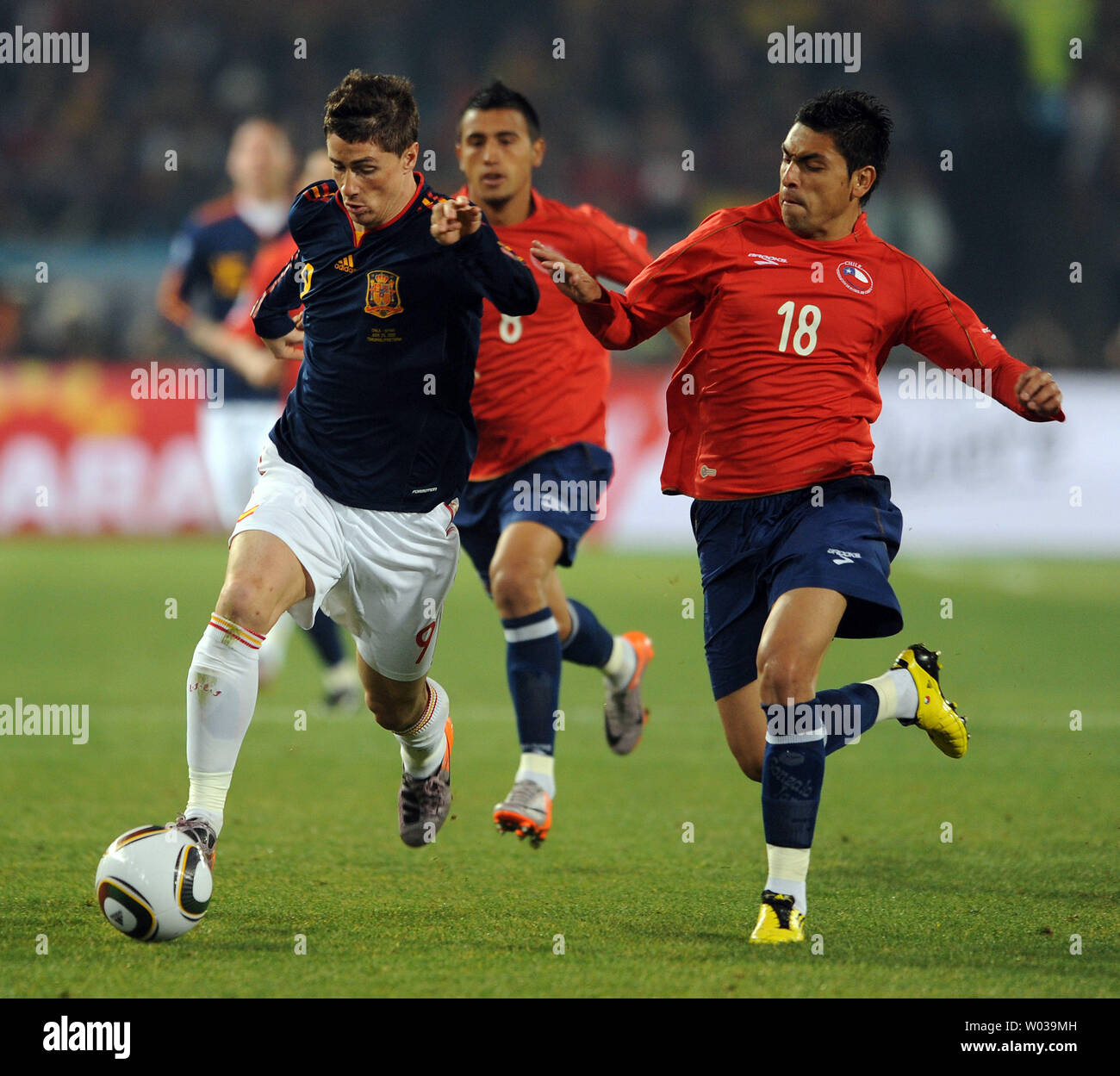 Gonzalo Jara of Chile and Fernando Torres of Spain chase the ball during the Group H match at the Loftus Versfeld Stadium in Pretoria, South Africa on June 25, 2010. UPI/Chris Brunskill Stock Photo