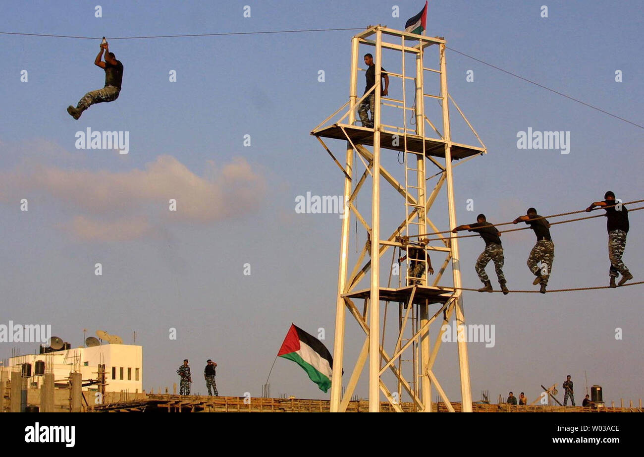 Palestinian police recruits show their skills during a graduation ...