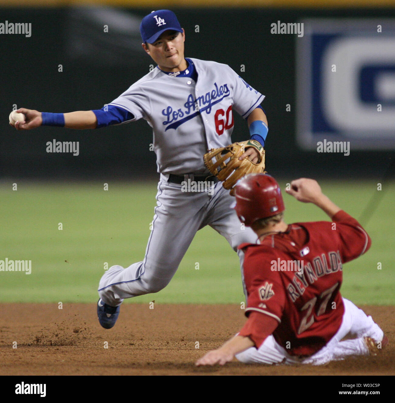 Los Angeles Dodgers shortstop Chin-Lung Hu, of Taiwan makes the relay throw for the double play as  Arizona Diamondbacks Mark Reynolds (R) slide into second base during the fourth inning at Chase Field in Phoenix on September 23, 2007. (UPI Photo/Art Foxall) Stock Photo