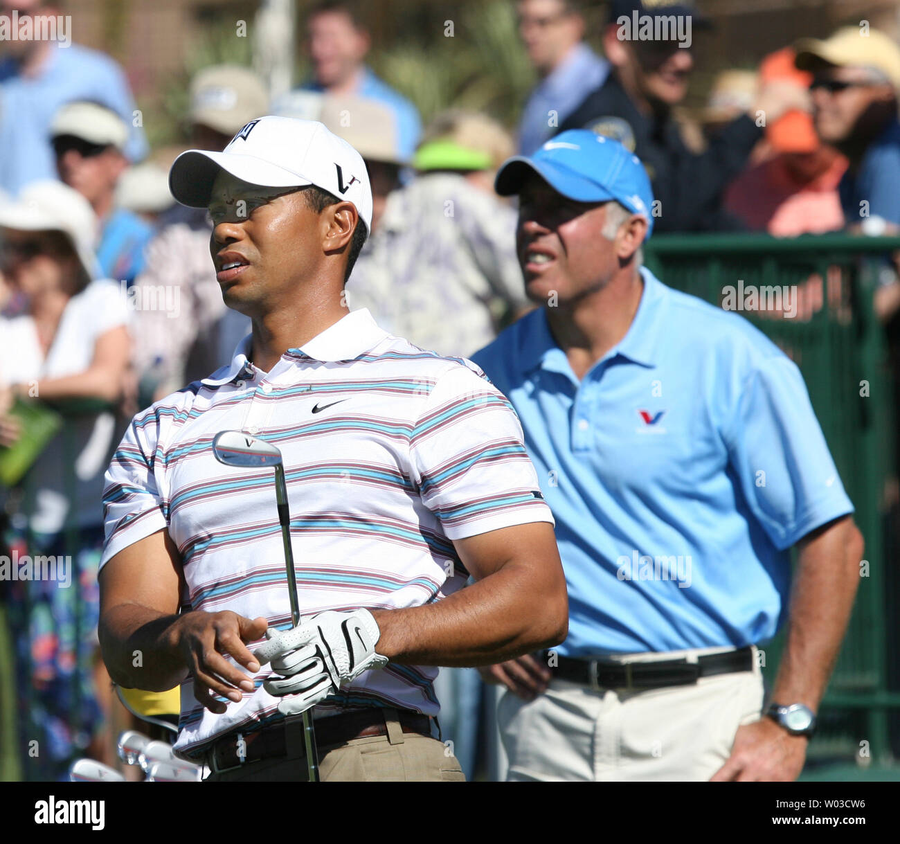 Tiger Woods watches his ball on the practice tee before his second