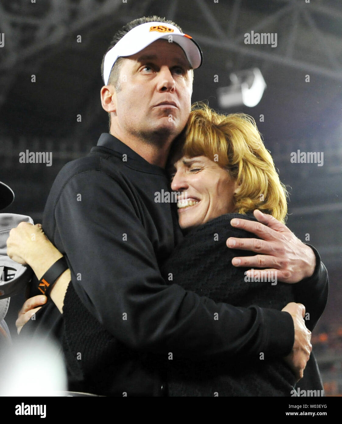 Oklahoma State head coach Mike Gundy gets a hug from his wife Kristen after Oklahoma State