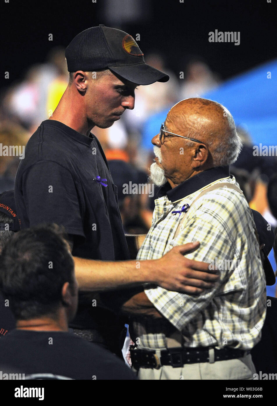 Lone survivor Brendan McDonough (L) is greeted by a man at a memorial