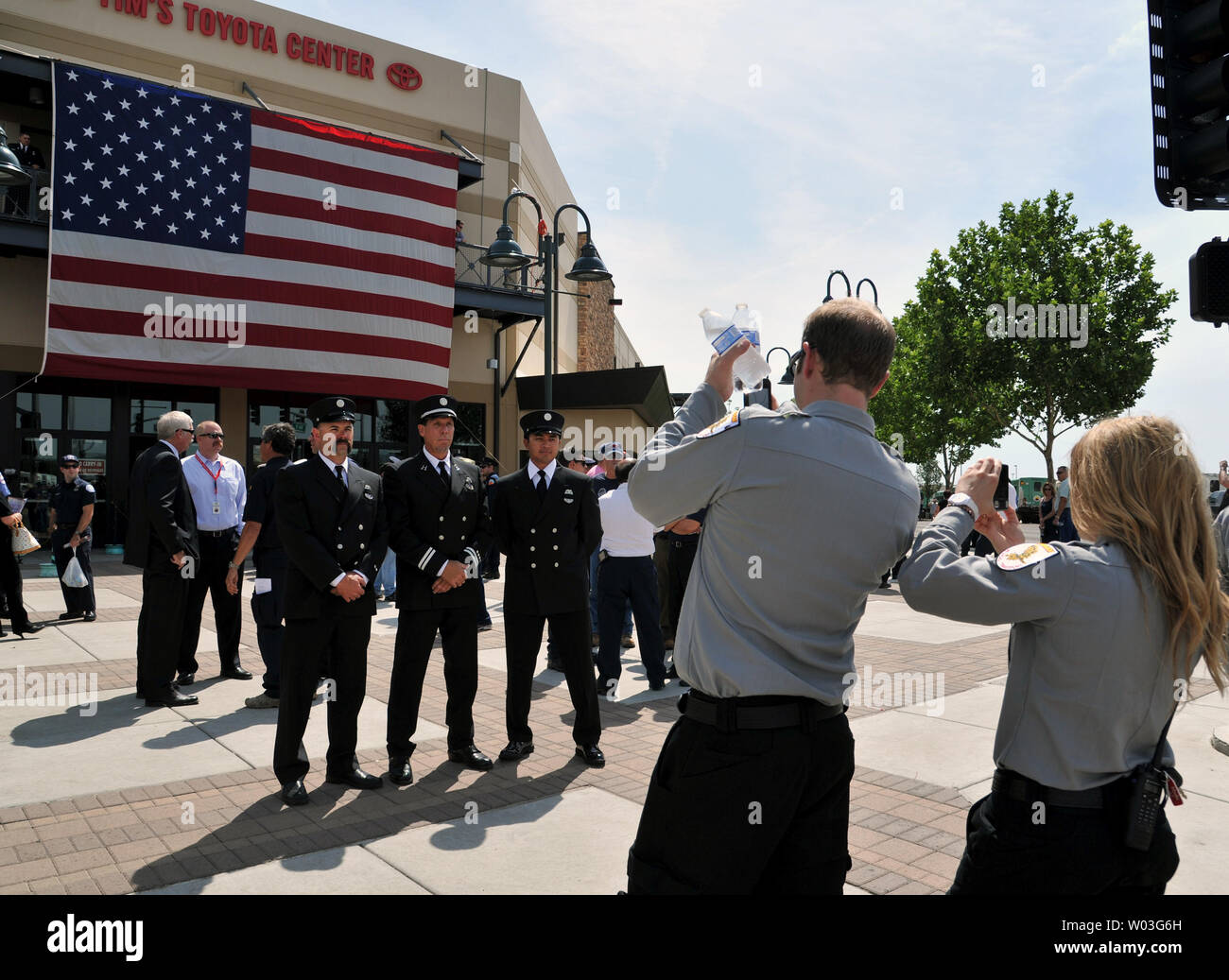 Firemen have their photo taken in front of Tim's Toyota Center before ...