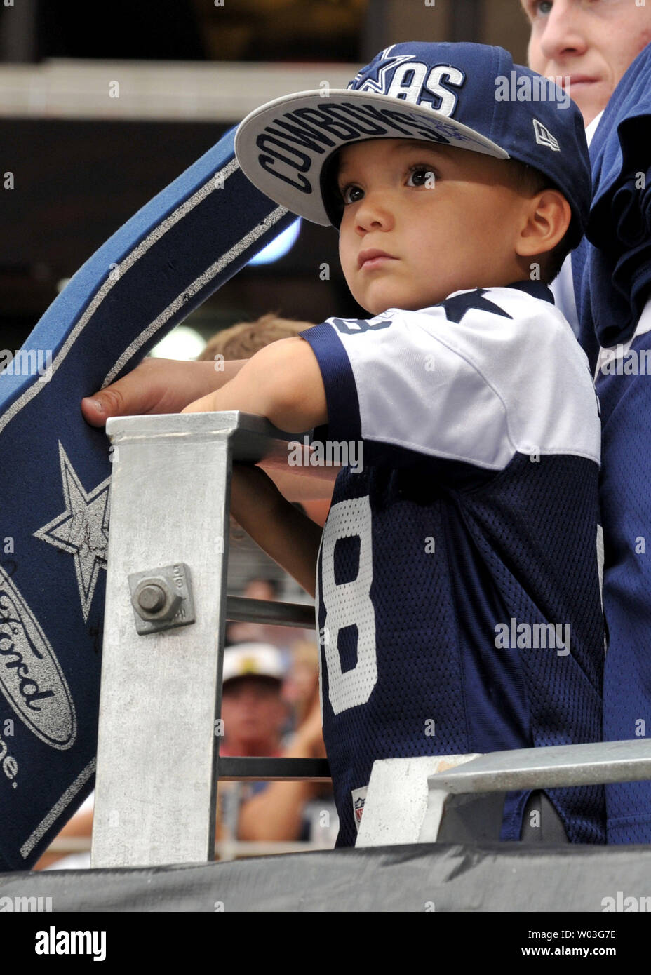 A young Dallas Cowboys fan watches players warm up before the Cowboys-Arizona  Cardinals, preseason game at University of Phoenix Stadium in Glendale,  Arizona on August 17, 2013. UPI/Art Foxall Stock Photo -