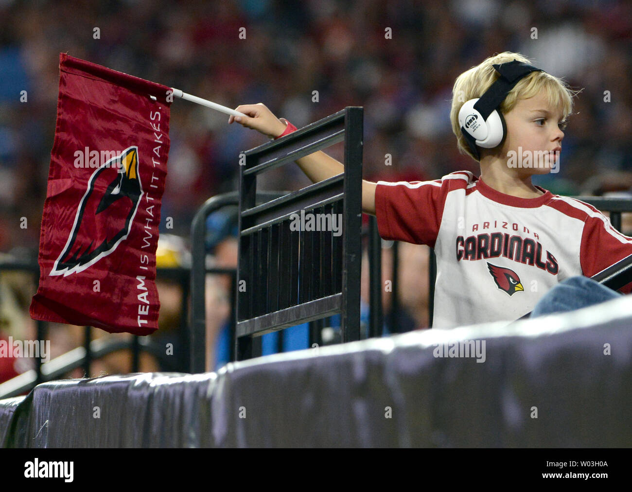 A Young Arizona Cardinals Fan Waves A Flag During The Cardinals