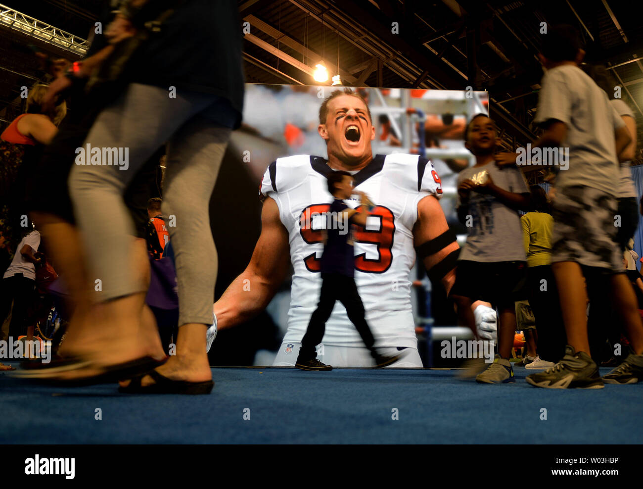 Fans pass a display of Houston Texans' J.J Watt at the NFL Experience in the run up to Super Bowl XLIX in Phoenix, Arizona on January 28, 2015. The New Engalnd Patriots will take on the Seattle Seahawks in Super Bowl XLIX on Sunday, February 1. Photo by Kevin Dietsch/UPI Stock Photo
