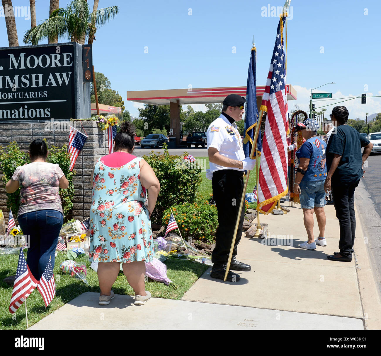 People place flowers in memory of Sen. John McCain at a makeshift