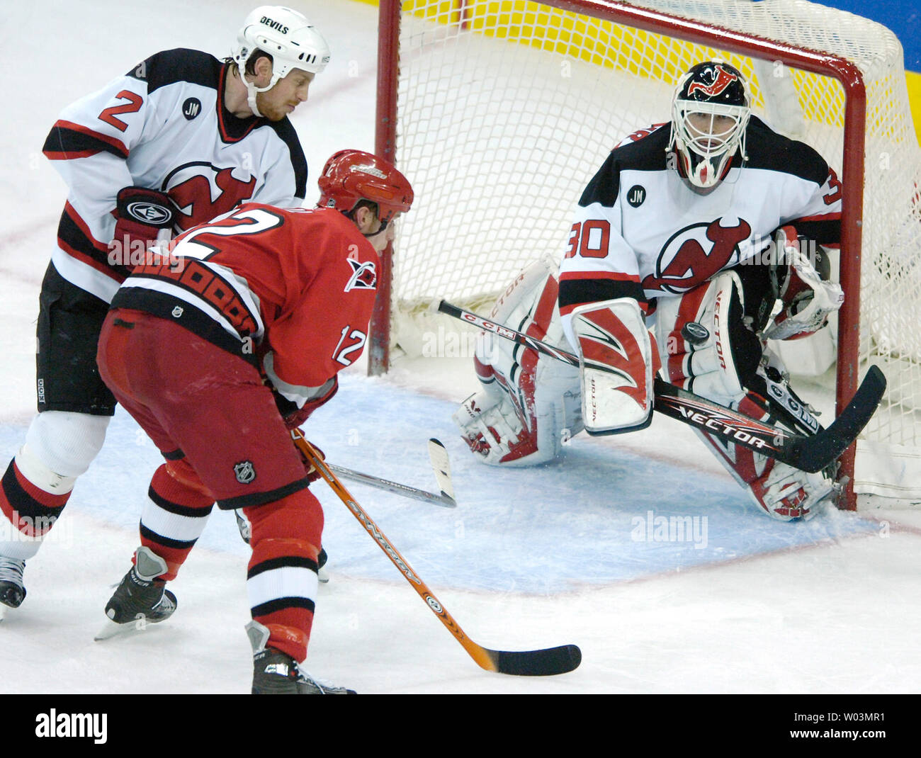 New Jersey Devils goaltender Martin Brodeur pokes the puck away