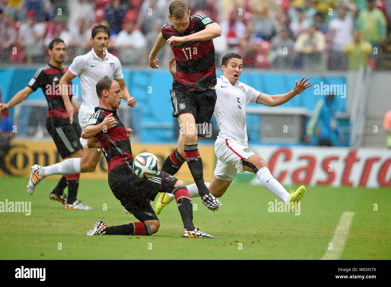 Matt Besler of USA competes with Per Mertesacker (C) of Germany during the 2014 FIFA World Cup Group G match at the Arena Pernambuco in Recife, Brazil on June 26, 2014. UPI/Chris Brunskill Stock Photo