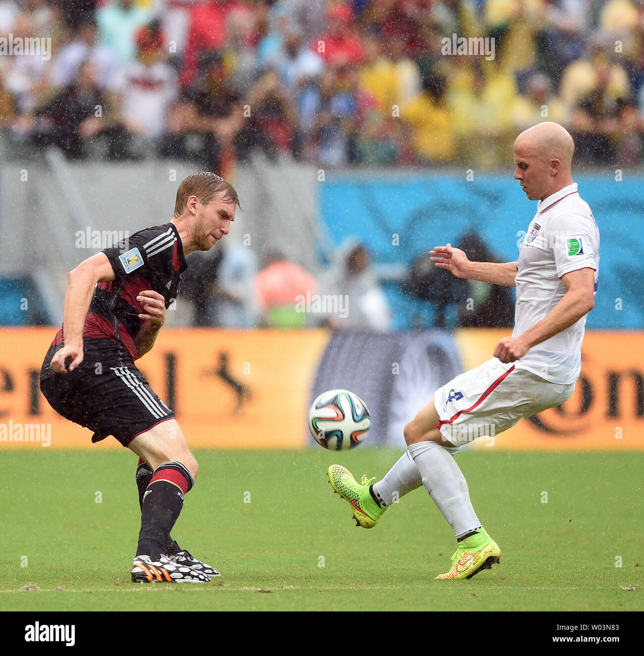 Michael Bradley of USA competes with Per Mertesacker (L) of Germany during the 2014 FIFA World Cup Group G match at the Arena Pernambuco in Recife, Brazil on June 26, 2014. UPI/Chris Brunskill Stock Photo