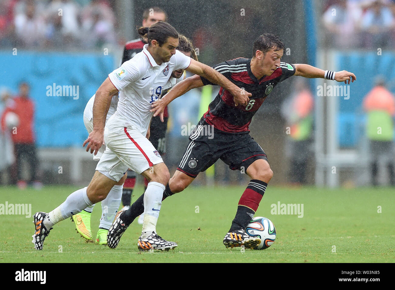 Graham Zusi (L) of USA challenges Mesut Ozil of Germany during the 2014 FIFA World Cup Group G match at the Arena Pernambuco in Recife, Brazil on June 26, 2014. UPI/Chris Brunskill Stock Photo