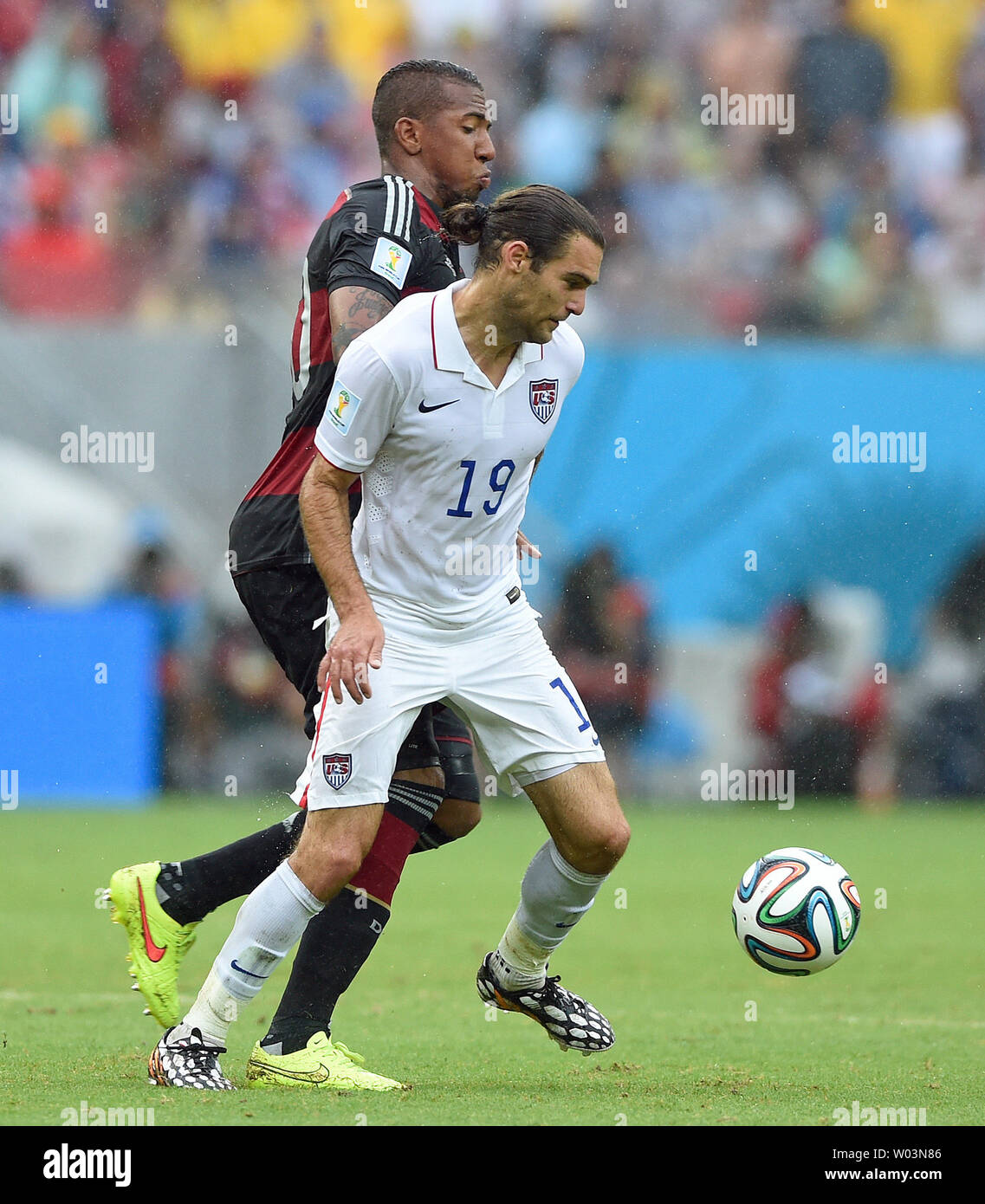 Graham Zusi of USA challenges Jerome Boateng (L) of Germany during the 2014 FIFA World Cup Group G match at the Arena Pernambuco in Recife, Brazil on June 26, 2014. UPI/Chris Brunskill Stock Photo