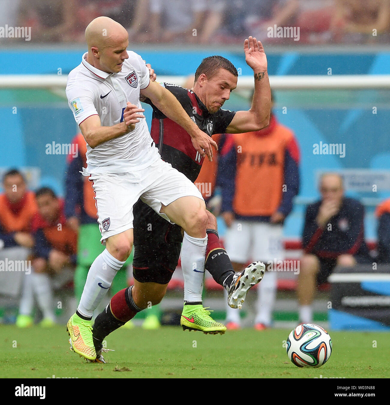 Michael Bradley (L) of USA competes with Lukasz Podolski of Germany during the 2014 FIFA World Cup Group G match at the Arena Pernambuco in Recife, Brazil on June 26, 2014. UPI/Chris Brunskill Stock Photo