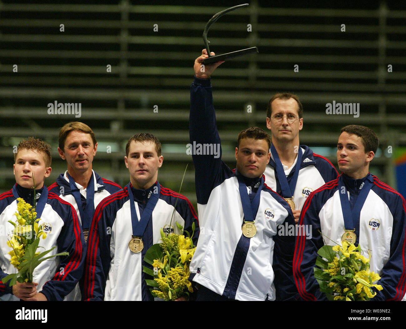 The American men's gymnastics squad celebrates their victory in the team competition of the Pan American Gymnastics Championships in Rio de Janeiro, Brazil on October 8, 2005. The team (from left) of Jonathan Horton, Mark Williams (coach), Joseph Hagerty, David Durante, Mike Burns (coach), and Guillermo Alvarez claimed the gold medal ahead of Puerto Rico and Canada.  (UPI Photo / Grace Chiu) Stock Photo