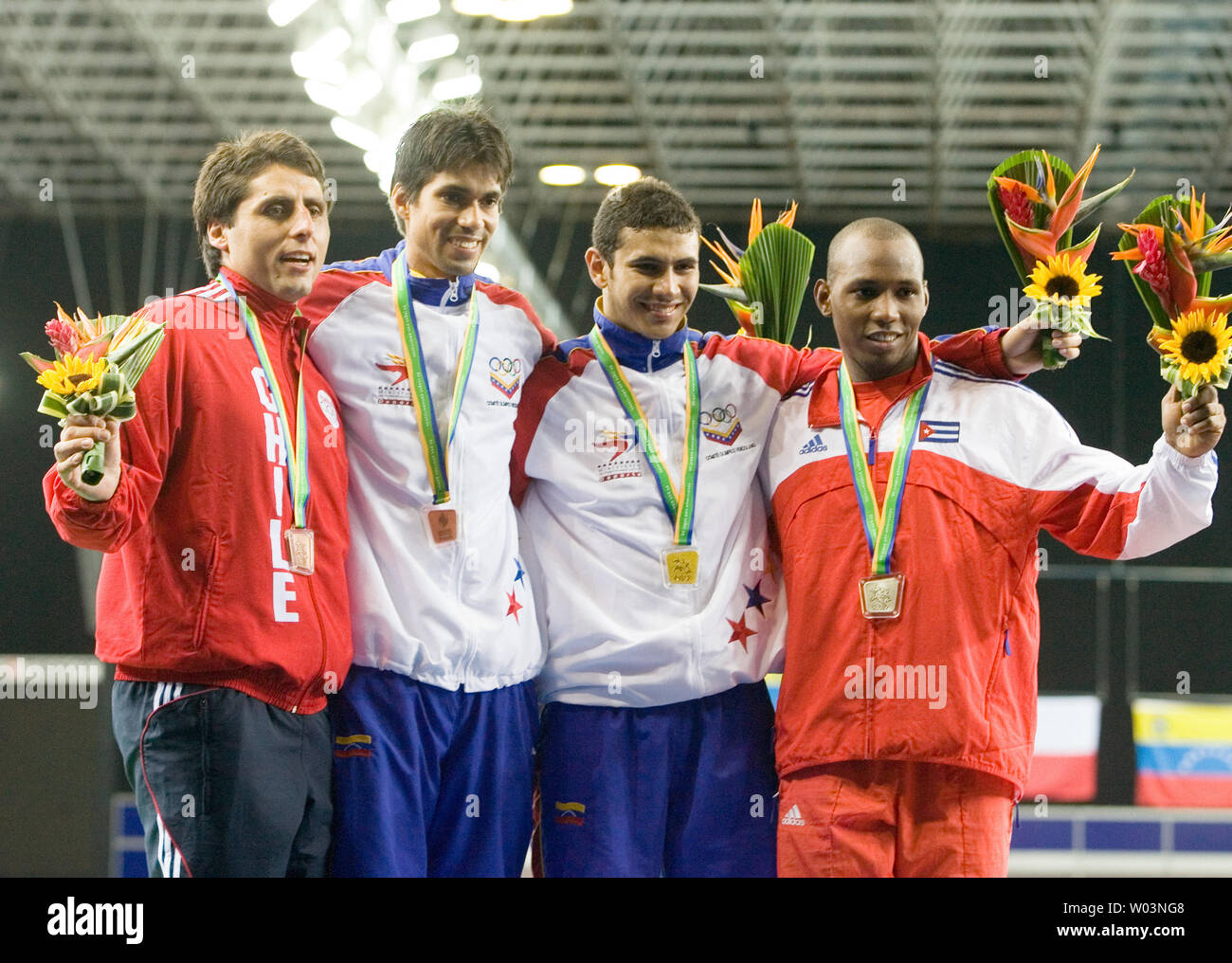 L. to R. on the podium, Chile's Paris Inostroza and Venezuela's Silvio Fernandez tied for bronze, Venezuela's Reuben Limardo with gold and Cuba's Andres Carrillo with silver in the  men's individual epee celebrate at Riocentro during the 2007 Pan Am Games in Rio de Janeiro, Brazil on July 16, 2007.   (UPI Photo/Heinz Ruckemann) Stock Photo