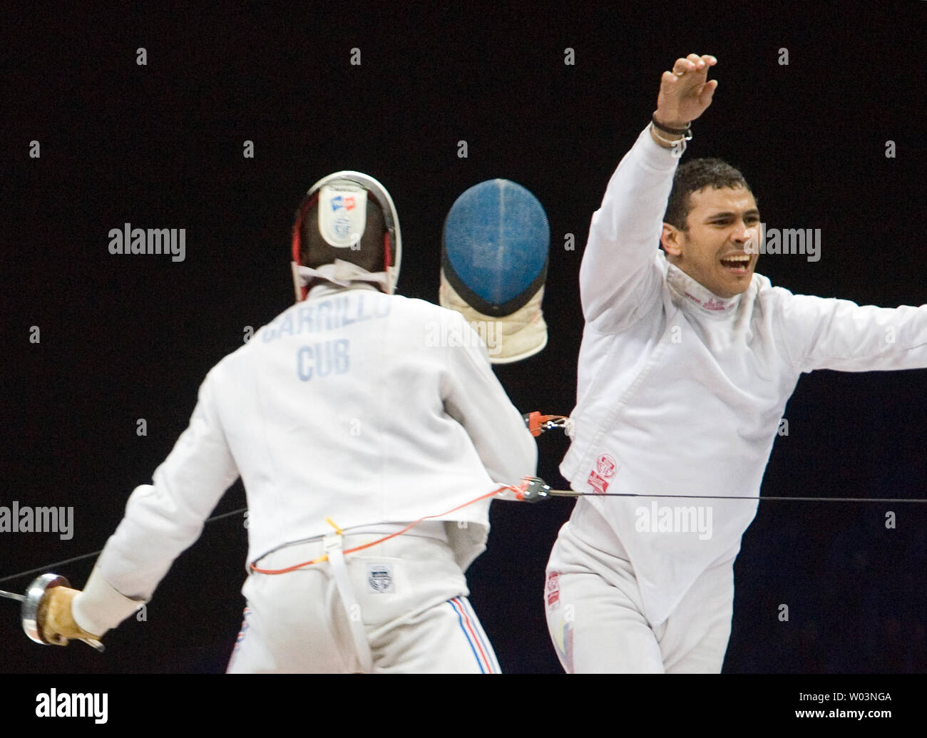 Venezuela's Reuben Limardo (R) celebrates after beating Cuba's Andres Carrillo 11-10 in overtime, winning gold in men's individual epee at Riocentro during the 2007 Pan Am Games in Rio de Janeiro, Brazil on July 16, 2007.   (UPI Photo/Heinz Ruckemann) Stock Photo