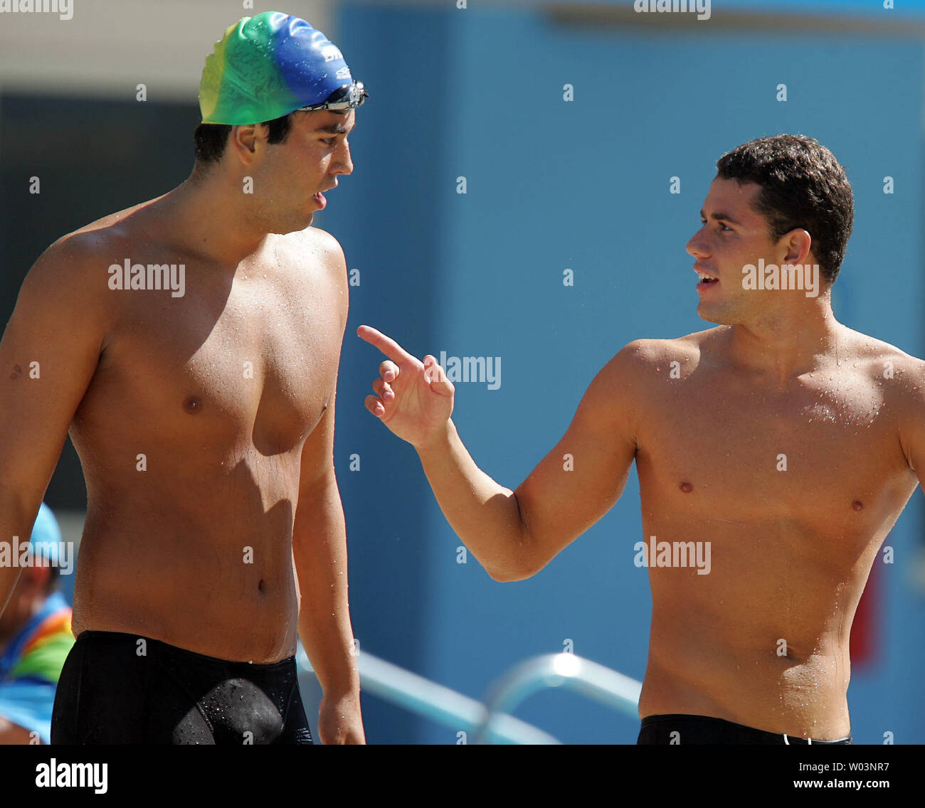 Brazilian swimmers Thiago Pereira (R) and Henrique Barbosa leave the pool following the 200-meter breakstroke finals in Rio de Janeiro, Brazil in the XV Pan American Games on July 21, 2007. Pereira won gold with a time of 2:13.51 minutes while Barbosa took the silver in 2:13.83 minutes. (UPI Photo/Grace Chiu). Stock Photo
