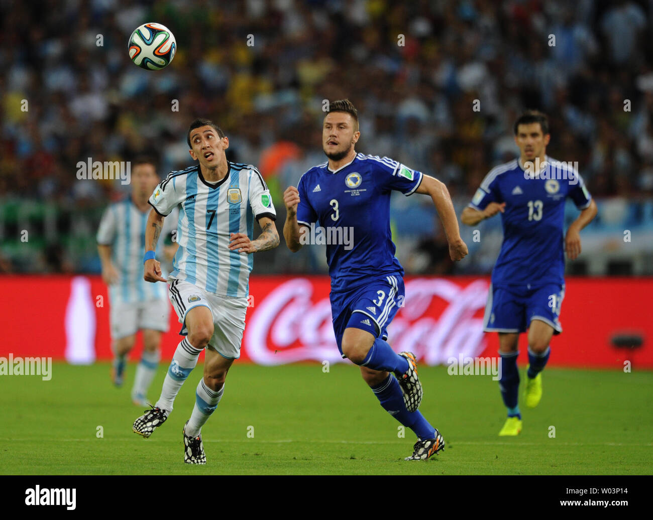 Angel Di Maria (L) of Argentina competes with Ermin Bicakcic of Bosnia Herzegovina during the 2014 FIFA World Cup Group F match at the Estadio do Maracana in Rio de Janeiro, Brazil on June 15, 2014. UPI/Chris Brunskill Stock Photo