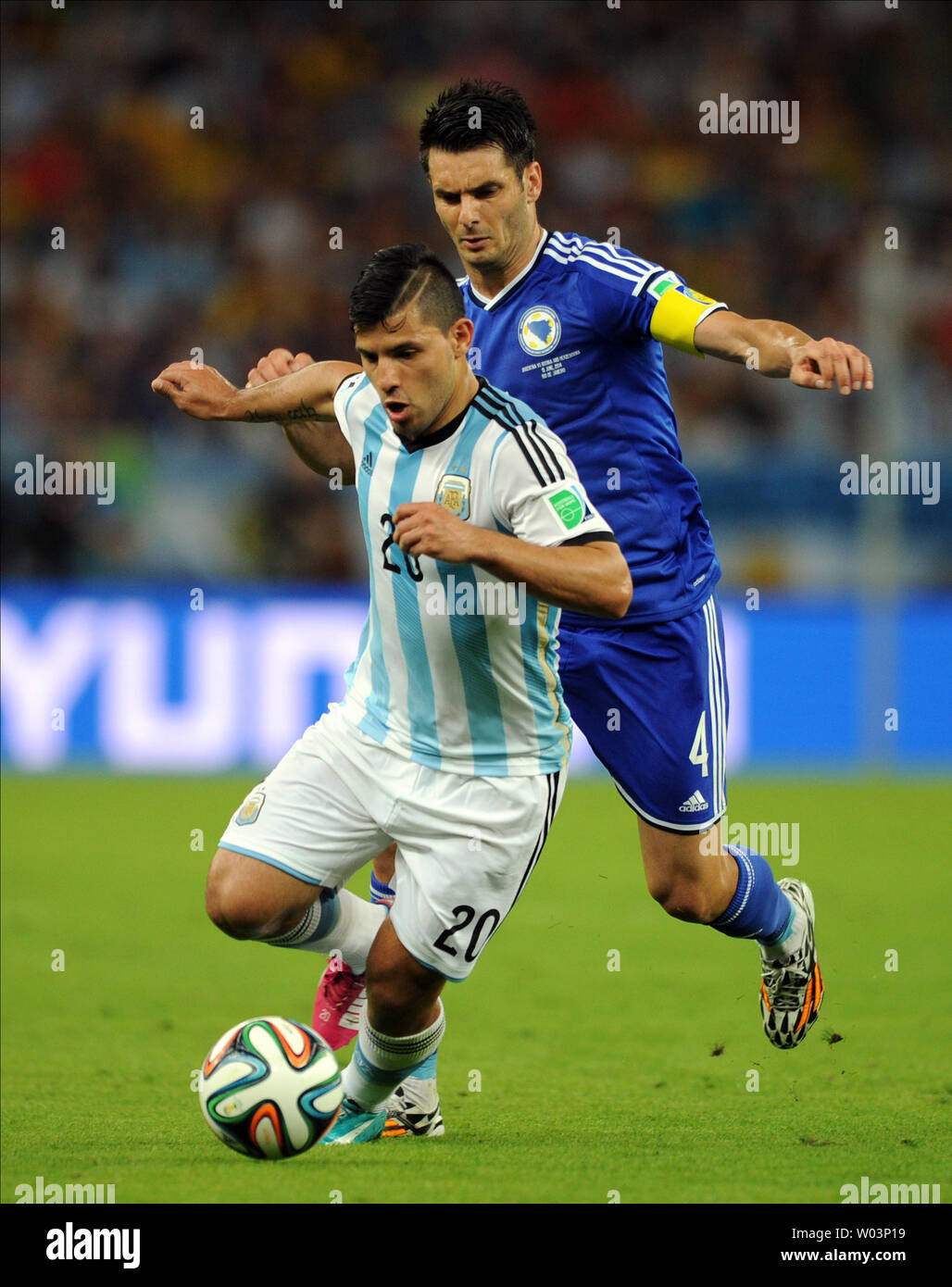 Sergio Aguero (L) of Argentina is chased by Emir Spahic of Bosnia Herzegovina during the 2014 FIFA World Cup Group F match at the Estadio do Maracana in Rio de Janeiro, Brazil on June 15, 2014. UPI/Chris Brunskill Stock Photo