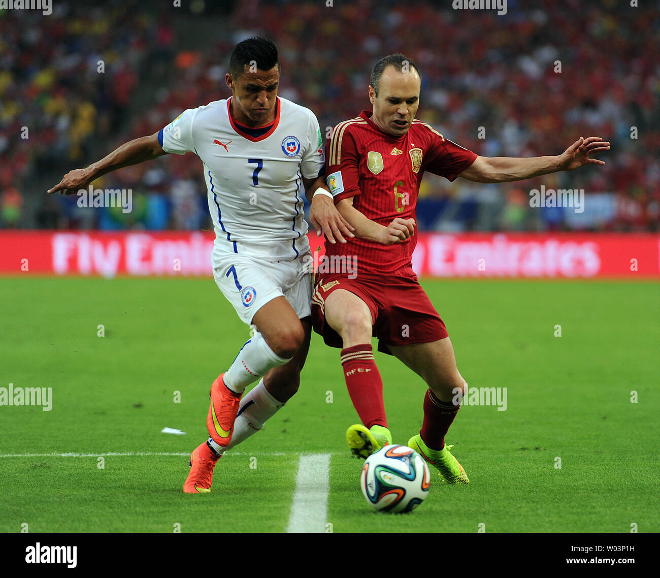 Andres Iniesta of Spain competes with Alexis Sanchez (L) of Chile during the 2014 FIFA World Cup Group B match at the Estadio do Maracana in Rio de Janeiro, Brazil on June 18, 2014. UPI/Chris Brunskill Stock Photo