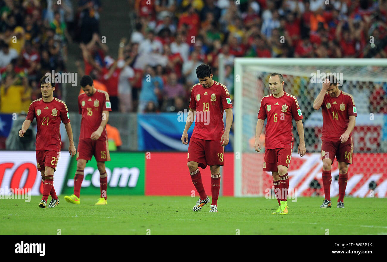 Diego Costa (C) and Andres Iniesta of Spain look dejected following Chile's second goal during the 2014 FIFA World Cup Group B match at the Estadio do Maracana in Rio de Janeiro, Brazil on June 18, 2014. UPI/Chris Brunskill Stock Photo
