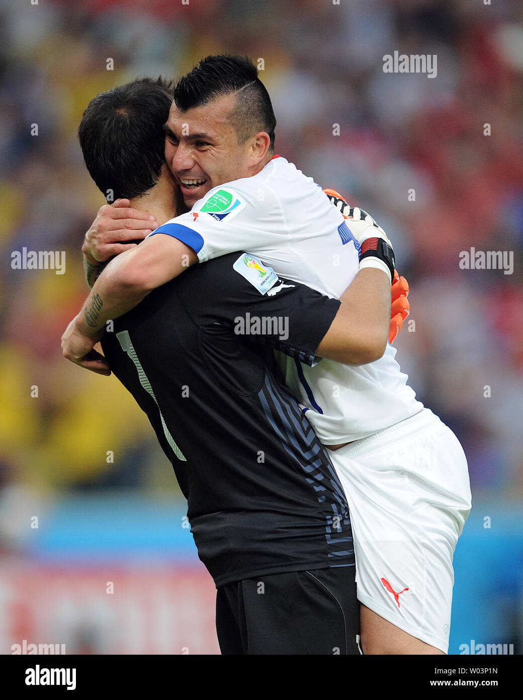 Claudio Bravo (L) of Chile embraces team-mate Gary Medel following the opening goal during the 2014 FIFA World Cup Group B match at the Estadio do Maracana in Rio de Janeiro, Brazil on June 18, 2014. UPI/Chris Brunskill Stock Photo