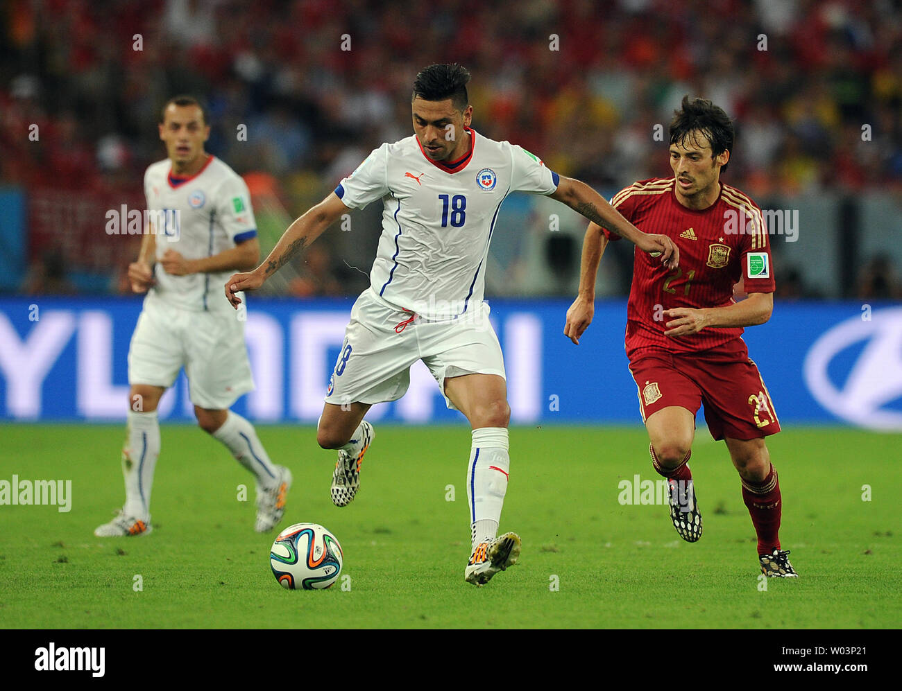 David Silva of Spain competes with Gonzalo Jara (L) of Chile during the 2014 FIFA World Cup Group B match at the Estadio do Maracana in Rio de Janeiro, Brazil on June 18, 2014. UPI/Chris Brunskill Stock Photo