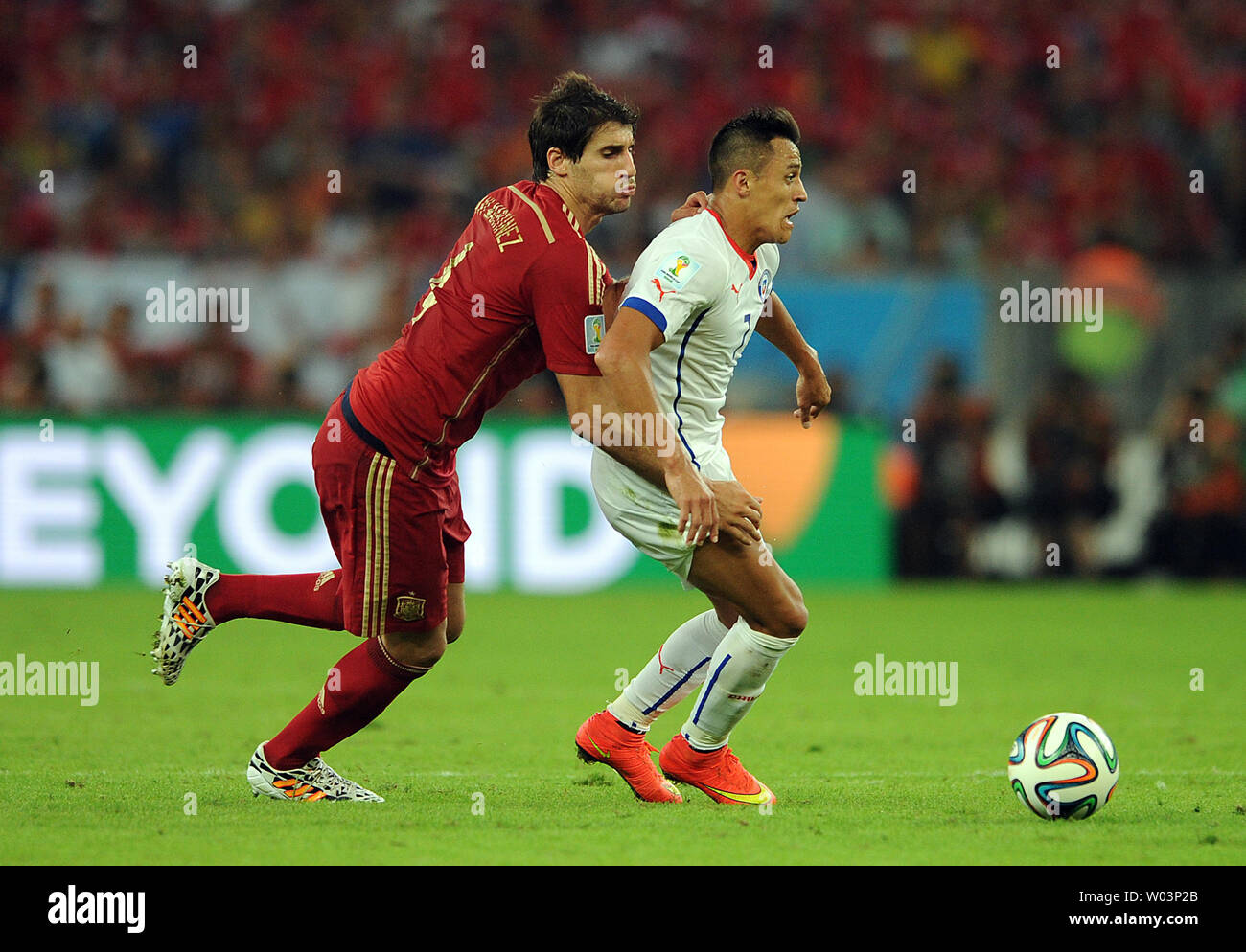 Javi Martinez (L) of Spain competes with Alexis Sanchez of Chile during the 2014 FIFA World Cup Group B match at the Estadio do Maracana in Rio de Janeiro, Brazil on June 18, 2014. UPI/Chris Brunskill Stock Photo