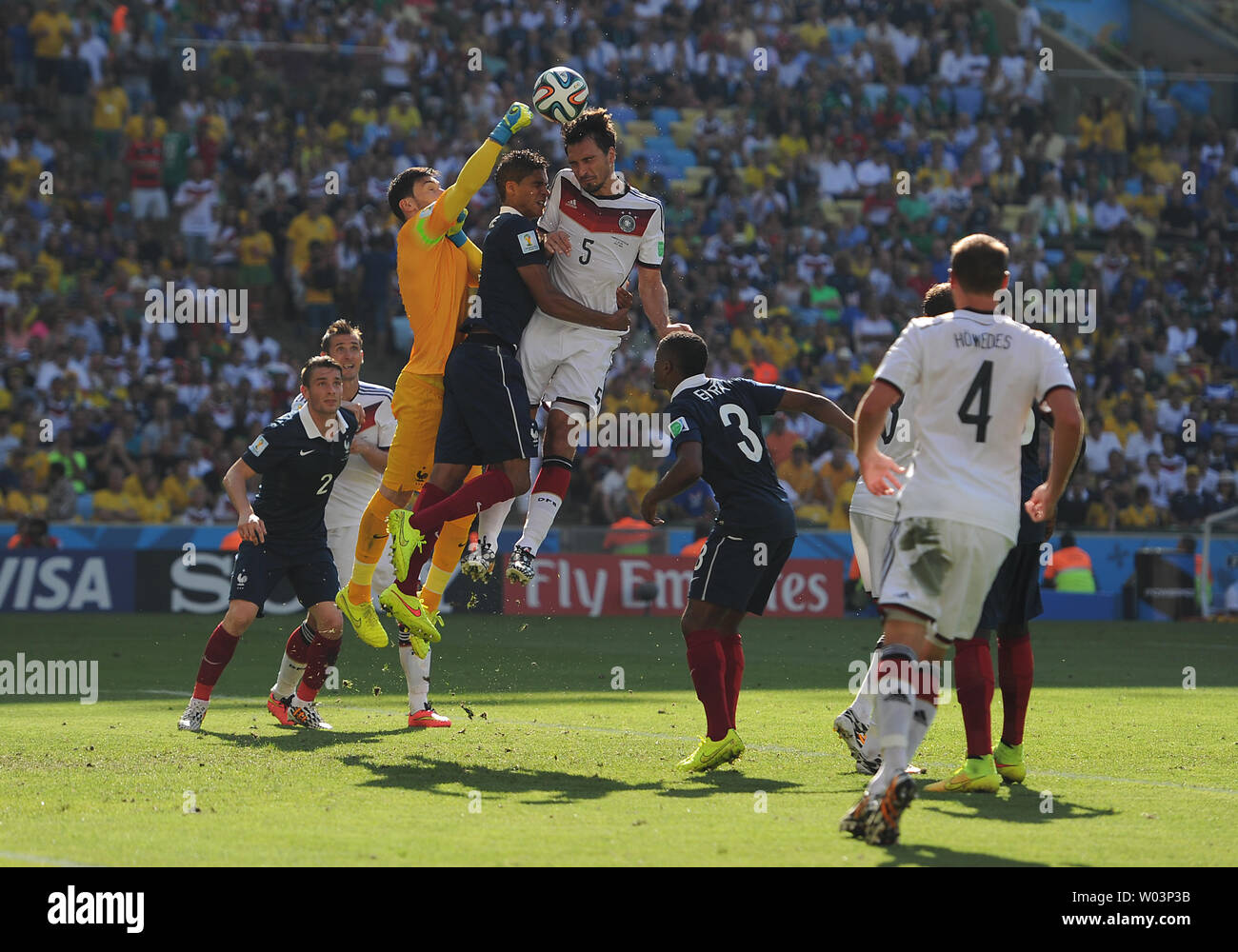 Hugo Lloris of France punches clear under pressure from Mats Hummels of Germany during the 2014 FIFA World Cup Quarter Final match at the Estadio do Maracana in Rio de Janeiro, Brazil on July 04, 2014. UPI/Chris Brunskill Stock Photo