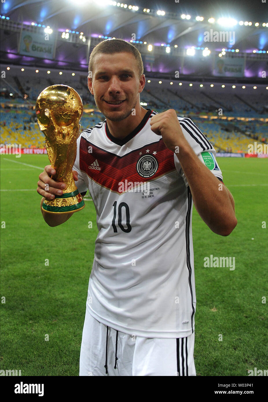 Lukas Podolski of Germany celebrates with the trophy following the 2014 FIFA World Cup Final at the Estadio do Maracana in Rio de Janeiro, Brazil on July 13, 2014. UPI/Chris Brunskill Stock Photo