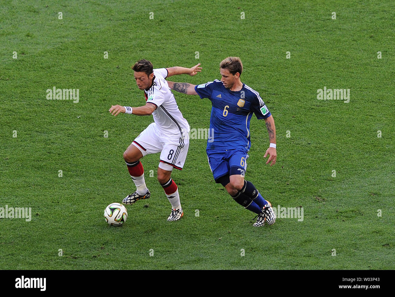 Mesut Ozil (L) of Germany competes with Lucas Biglia of Argentina during the 2014 FIFA World Cup Final at the Estadio do Maracana in Rio de Janeiro, Brazil on July 13, 2014. UPI/Chris Brunskill Stock Photo