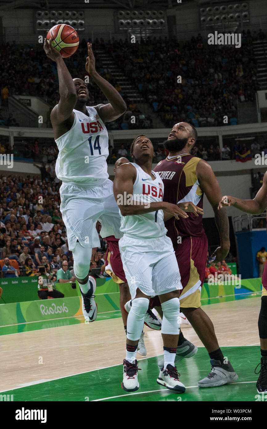 United States forward Draymond Green (14) goes for the jump shot as United States guard Kyle Lowry (7) blocks Venezuela center Gregory Echenique (0) during basketball competition at the Carioca Arena 1 in Rio de Janeiro, Brazil, August 8, 2016. The USA team overcame a slow start coasting to an easy 113-69 win over Venezuela.     Photo by Richard Ellis/UPI Stock Photo