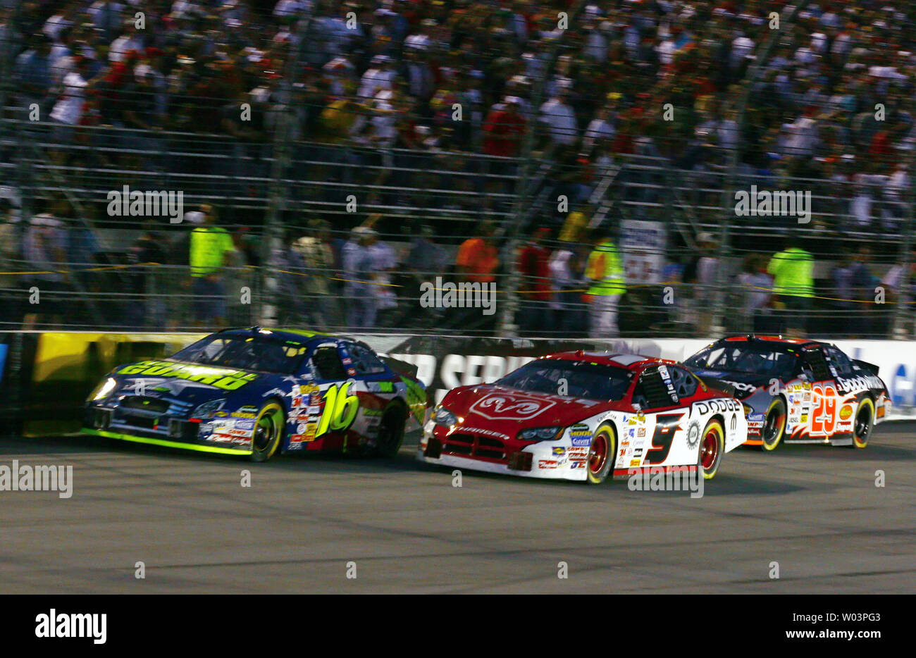 Greg Biffle, driver of the #16 National Guard Ford, leads Kasey Kahne, driver of the #9 Dodge Dealers/UAW Dodge, and Kevin Harvick, driver of the #29 GM Goodwrench Chevrolet during the Crown Royal 400, at the Richmond International Raceway in Richmond, VA on May 6, 2006. (UPI Photo/Christopher Rossi) Stock Photo