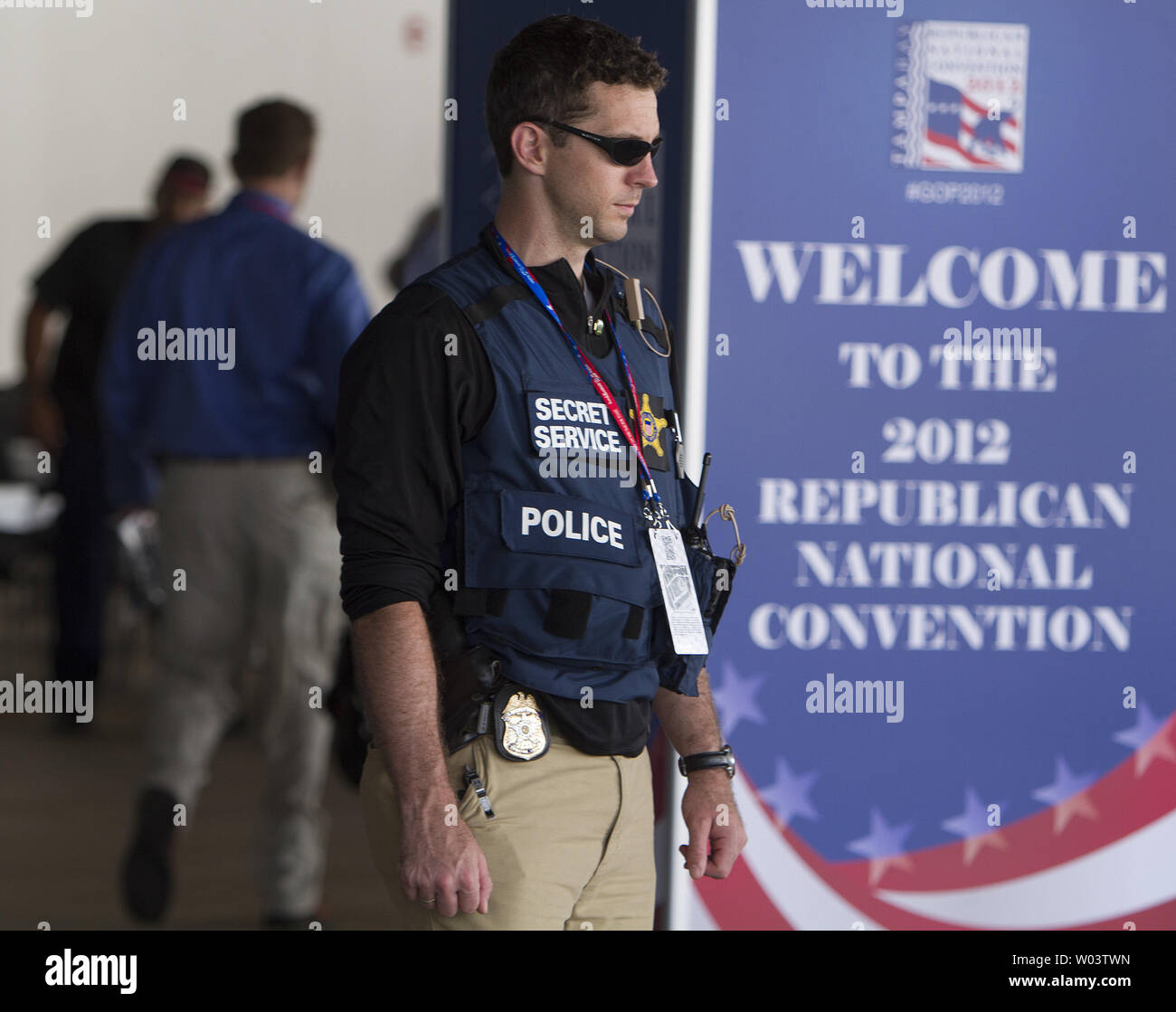 Delegates arriving early pass a Secret Service agent stationed at an entrance at the 2012 Republican National Convention at Tampa Bay Times Forum in Tampa on August 28, 2012.   UPI/Gary C. Caskey Stock Photo