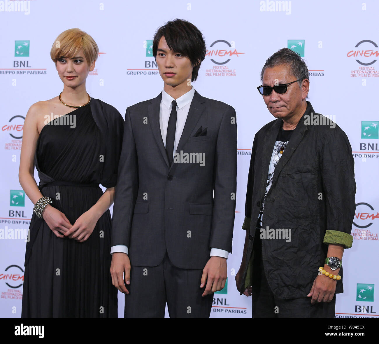 Hirona Yamazaki (L), Sota Fukushi (C) and Takashi Miike arrive at a photo call for the film 'As the Gods Will' during the 9th annual Rome International Film Festival in Rome on October 18, 2014.   UPI/David Silpa Stock Photo