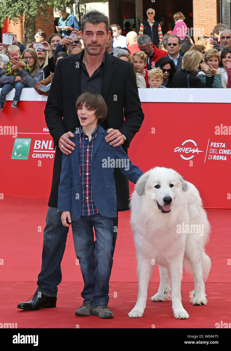 Felix Bossuet (front) and Thierry Neuvic arrive on the red carpet before the screening of the film 'Belle et Sebastien, l'aventure continue' at the 10th annual Rome International Film Festival in Rome on October 17, 2015.   UPI/David Silpa Stock Photo