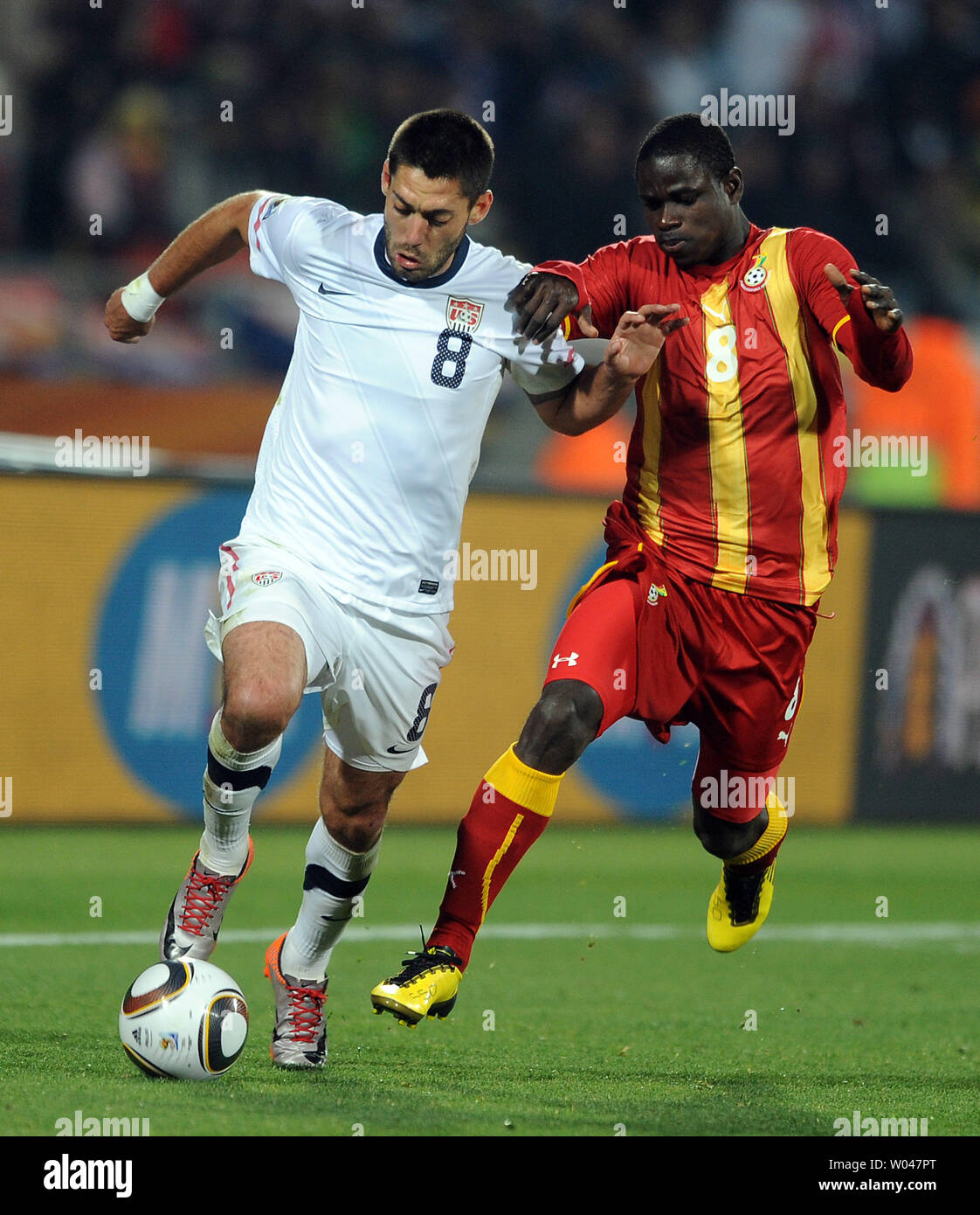 Clint Dempsey of USA and Jonathan Mensah of Ghana chase the ball during the Round of 16 match at the Royal Bafokeng Stadium in Rustenburg, South Africa on June 26, 2010. UPI/Chris Brunskill Stock Photo