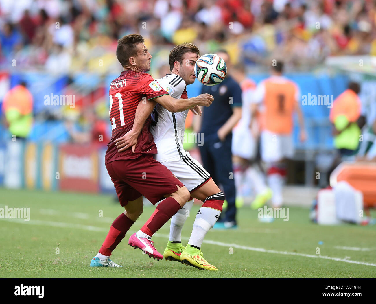 Mario Gotze of Germany competes with Joao Pereira (L) of Portugal during the 2014 FIFA World Cup Group G match at the Arena Fonte Nova in Salvador, Brazil on June 16, 2014. UPI/Chris Brunskill Stock Photo