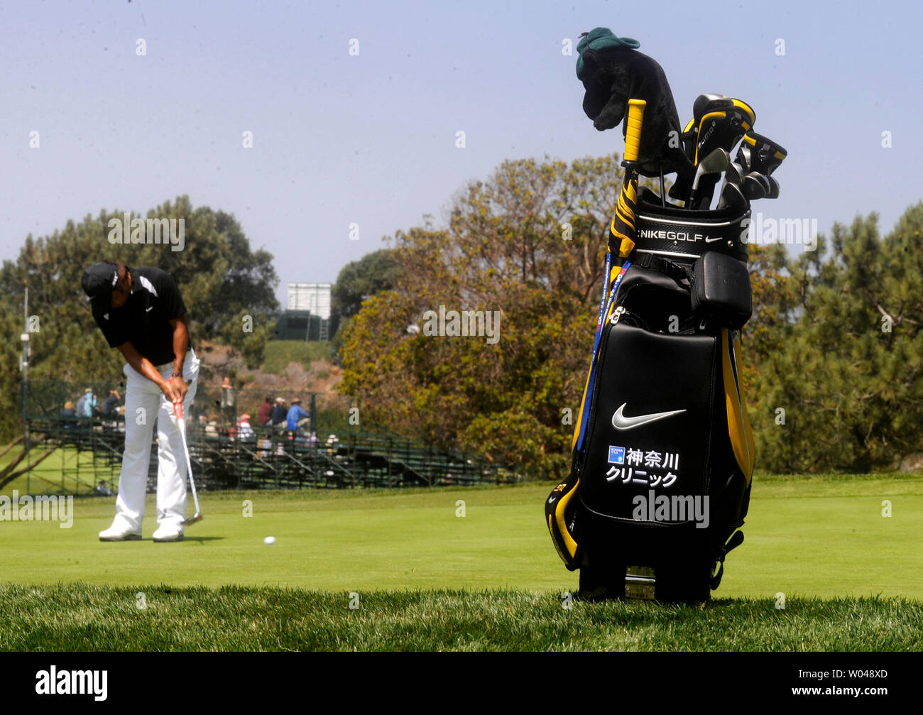 Japanese golfer Shingo Katayama's golf bag is seen on the 8th green as he putts in the background during a practice round prior to the 2008 U.S. Open at Torrey Pines Golf Course in San Diego on June 11, 2008. (UPI Photo/Kevin Dietsch) Stock Photo