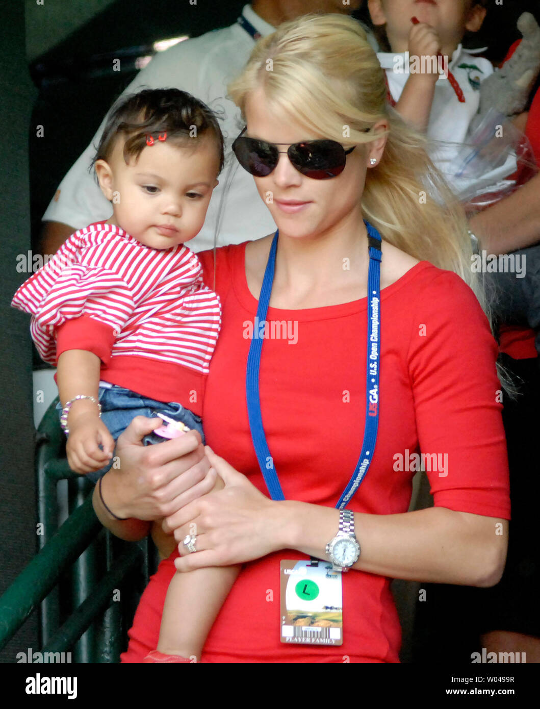 Tiger Woods's wife Elin Nordegren carries their baby girl Sam as they watch Woods putt on the 18th green during the final round of the US Open at Torrey Pines Golf Course in San Diego on June 15, 2008. Woods finished his round tied for first with Rocco Mediate. A playoff round between Woods and Mediate will be held tomorrow. (UPI Photo/Earl Cryer) Stock Photo