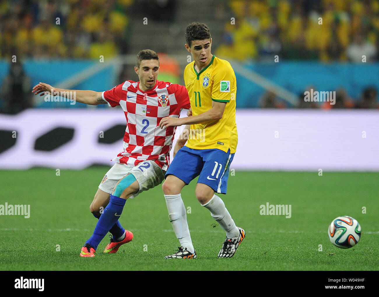 Oscar (R) of Brazil in action with Sime Vrsaljko of Croatia during the 2014 FIFA World Cup Group A match at the Arena Corinthians in Sao Paulo, Brazil on June 12, 2014. UPI/Chris Brunskill Stock Photo